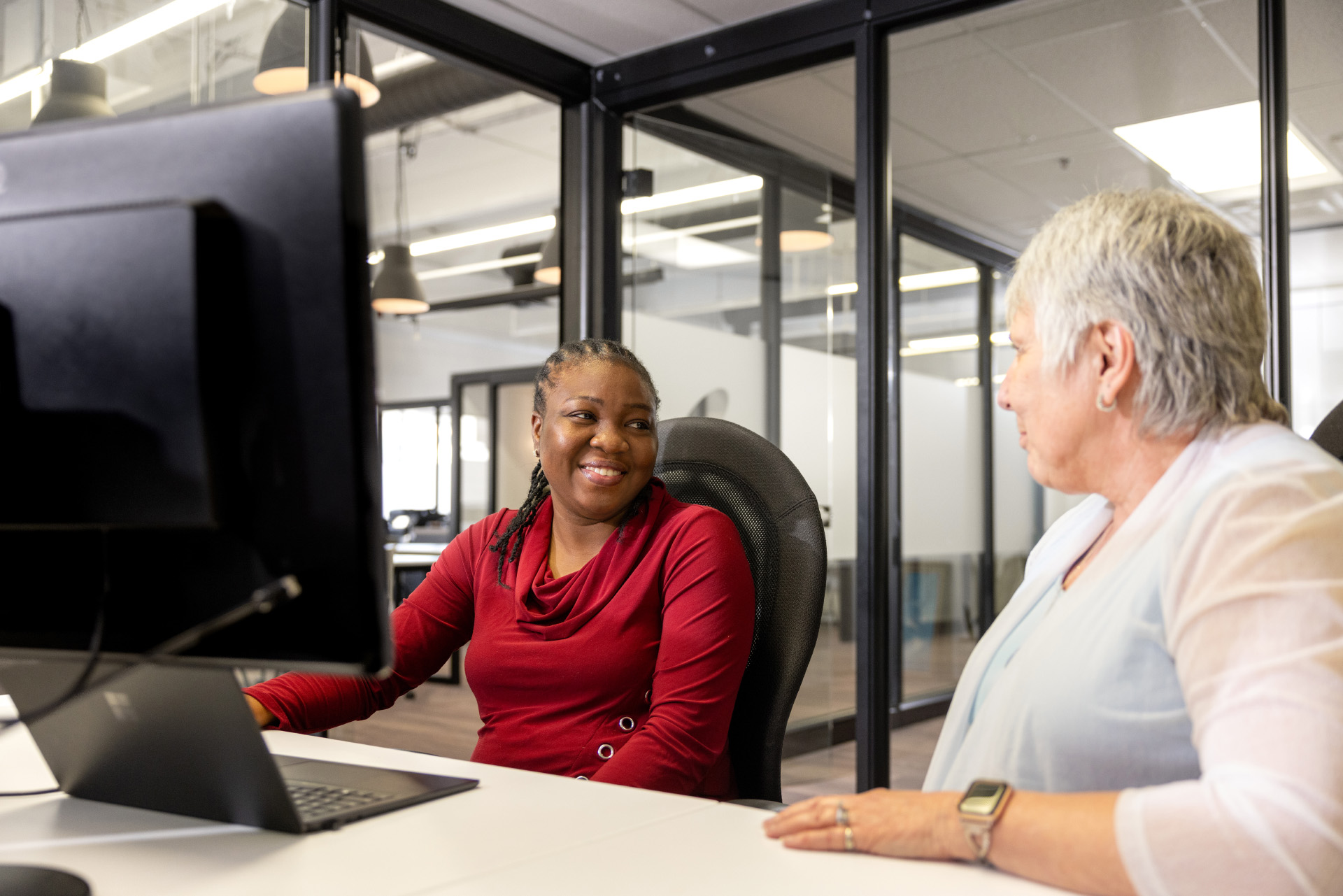 Employees Talking in Front of Computer Monitor