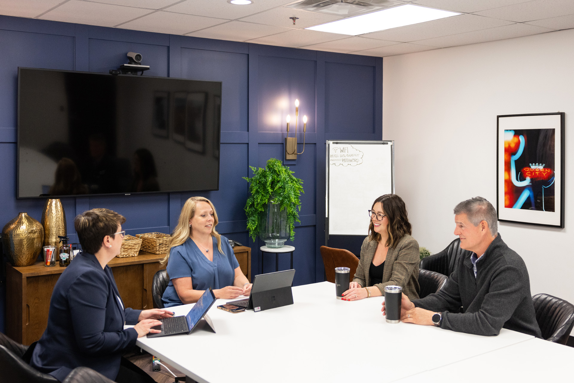 Meeting Room with Four Employees